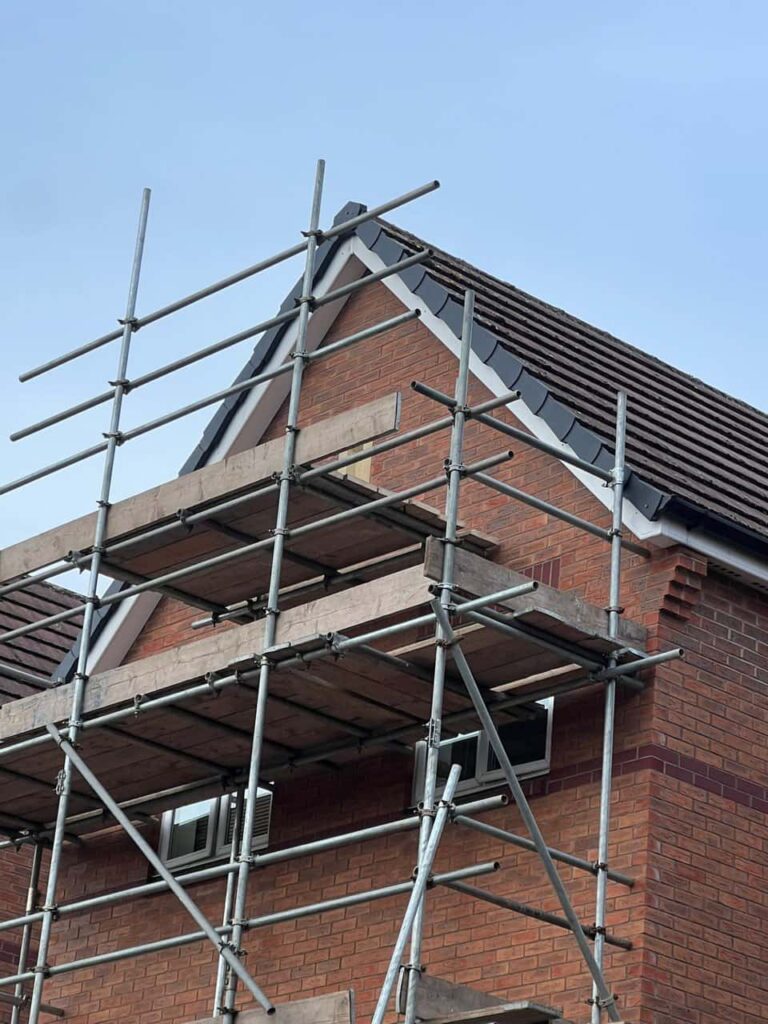 This is a photo of a roof which has just been repaired. There is a scaffold located at the gable end for access onto the roof. Works carried out by Edenbridge Roofing Repairs